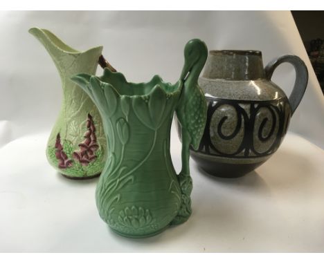 A ports pottery jug along with a Carltonware jug and a slyvac Matt green 1960 stork jug.