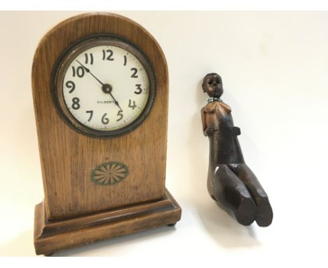 A tribal carved pipe body in the female form and a Gilbert mantle clock, dimensions 8x15x22cm