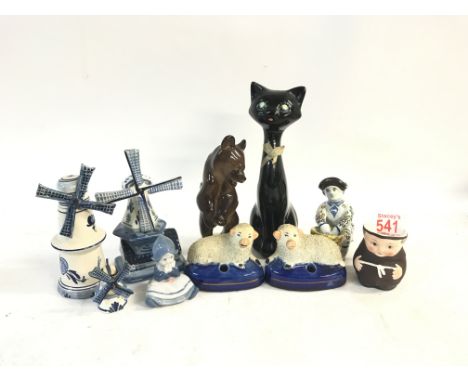 A collection of ceramic items including: ceramic cat figure, Lomonsov bear, a goebel monk mug, two angry sheep figures, three