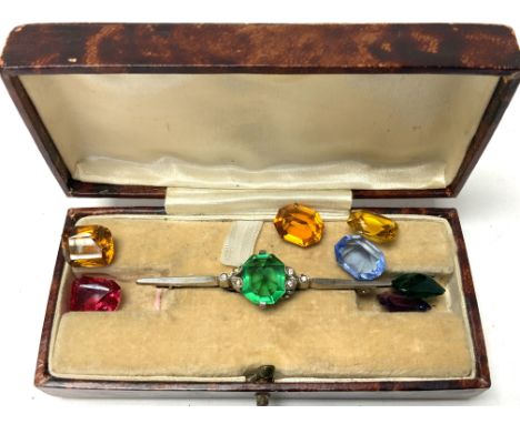 A vintage silver bar brooch with multiple coloured interchangeable stones.