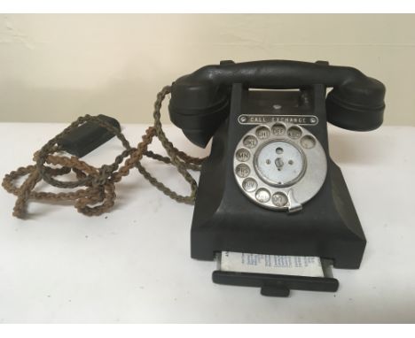 A Vintage black Bakelite telephone.