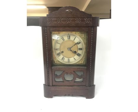Two clocks including A walnut mantel clock with a silvered dial and An oak mantle clock with key and pendulum
