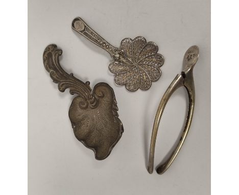 Silver caddy spoon of scrolling vine leaf form, another filigree c1820 and a wishbone tongs, 1907. 32g (3). Condition report: