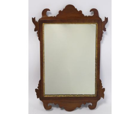 George III style walnut fret carved wall mirror with inlaid stringing and moulded gilt slip, 52cm high. 