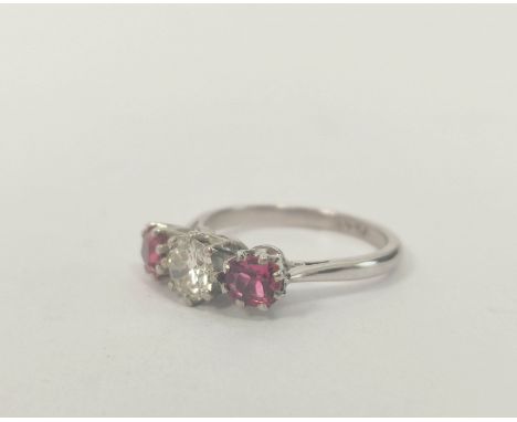 Three stone ring with diamond brilliant approx .6ct, flanked by two pink tourmalines in white gold, probably 18ct, size 'J½'.