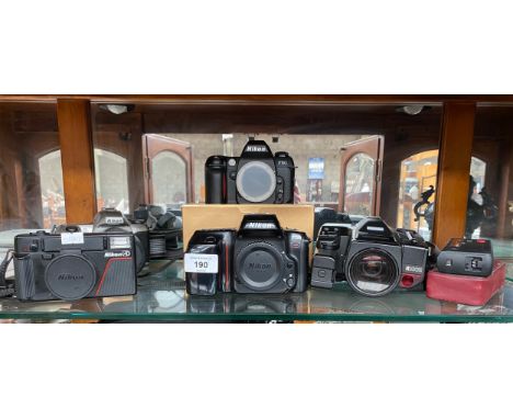 A Shelf of camera items to include Nikon F50, F65, F80, Nikon AD, Mirri Ricoh cameras. 