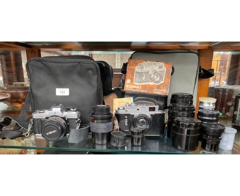 A Shelf of camera items to include Minolta X-300 Camera, Zorki- 4k camera and various lenses. 