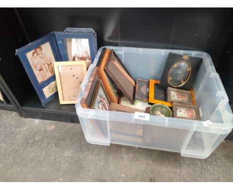Shelf of antique photo frames of various sizes. 
