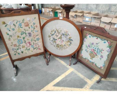 Three antique fire screens with floral tapestry design. 