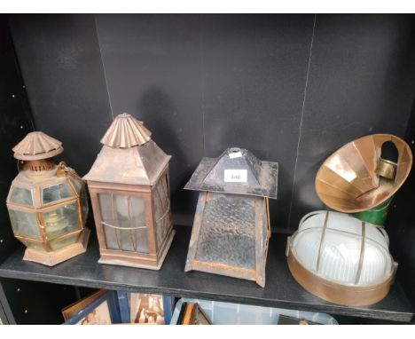 Shelf of vintage copper and brass lanterns. 