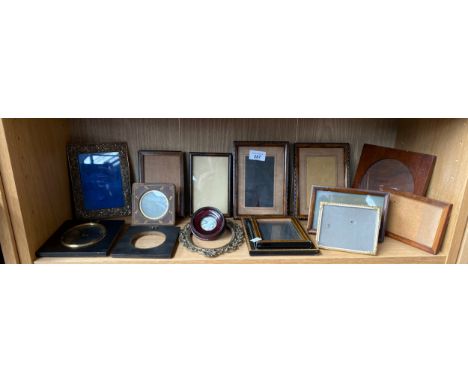 A Shelf of antique photoframes of various sizes