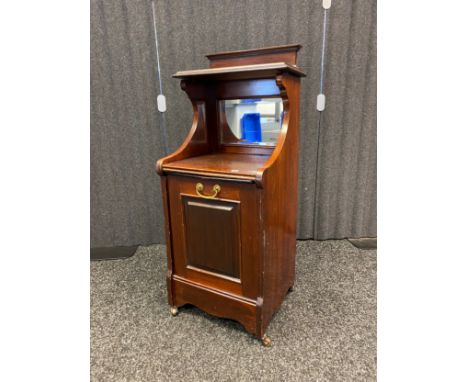 Mahogany side cabinet, the top with shelf above a mirrored back and cupboard opening to interior storage, raised on castor fe