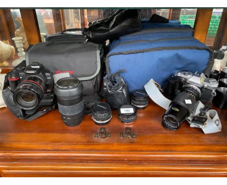 A Shelf of camera items to include Canon EOS 350D Digital camera, Jessops Skylight 1a filter 58mm lens, Olympus OM 30 Camera 