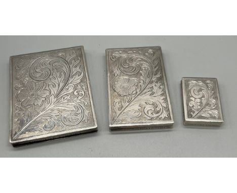 A group of three Swedish silver cases I. I. Stack, Stenungsund mid-20th century, as a compact, mirror to interior, scrolling 