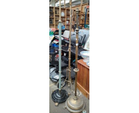 Three antique rise and fall paraffin lamp bases. [Brass bodies] 
