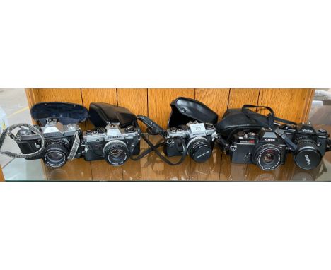 A Shelf of cameras to include Pentax K2, Olympus OM10, Konica Autoreflex TC and Vivitar V3800N. 