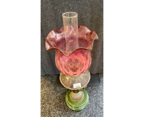 Victorian porcelain and glass oil lamp with cranberry glass shade. 