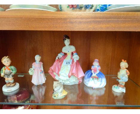Shelf of Royal Doulton and Hummel figures. 
