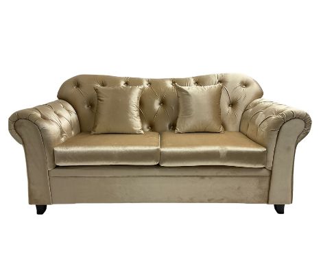 Chesterfield shaped two seat sofa, upholstered in buttoned champagne fabric, with scatter cushionsDimensions: Height:&nbsp;89