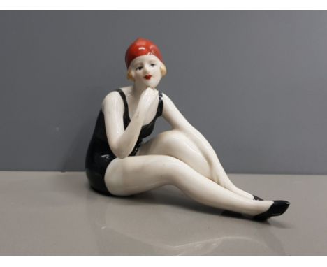 A CERAMIC ART DECO FIGURE OF A FLAPPER GIRL