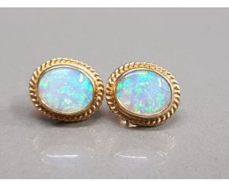 9CT YELLOW GOLD OPAL STUDS SET IN A RUB OVER SETTING WITH BEAD EDGING 3.2G GROSS