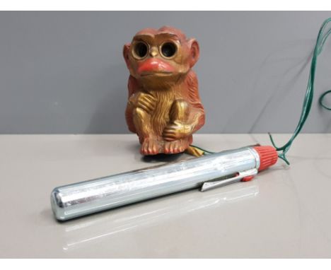 CAST METAL MONKEY ORNAMENT WITH LIGHT UP EYES AND BATTERY PEN ATTACHED