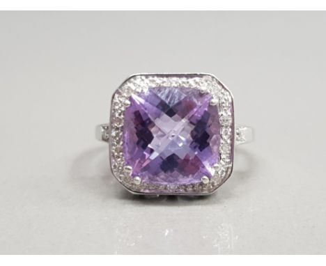 9CT WHITE GOLD AMETHYST AND DIAMOND CLUSTER RING FEATURING AN AMETHYST STONE IN THE CENTRE SURROUNDED BY DIAMONDS