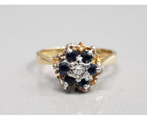 18CT YELLOW GOLD SAPPHIRE AND DIAMOND CLUSTER RING FEATURING A BRILLIANT ROUND CUT DIAMOND SET IN THE CENTRE SURROUNDED BY 6 