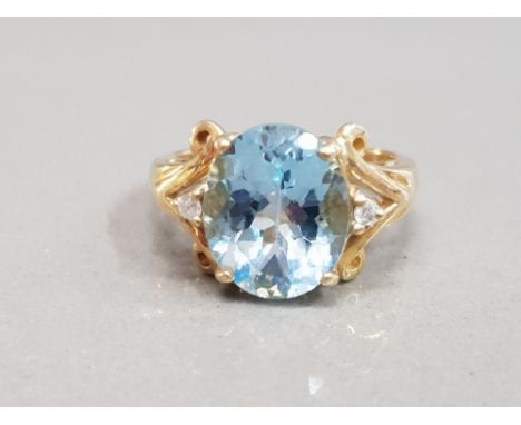 9CT YELLOW GOLD BLUE STONE RING COMPRISING OF A BLUE STONE SET IN THE CENTRE WITH A DIAMOND SET EITHER SIDE SIZE M1/2 5.3G GR