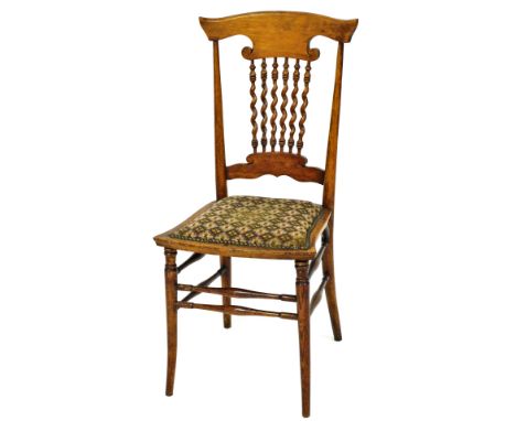 A Victorian oak and beech bedroom chair, with curved crest rail and barley twist slats, button fringed seat, raised on outswe