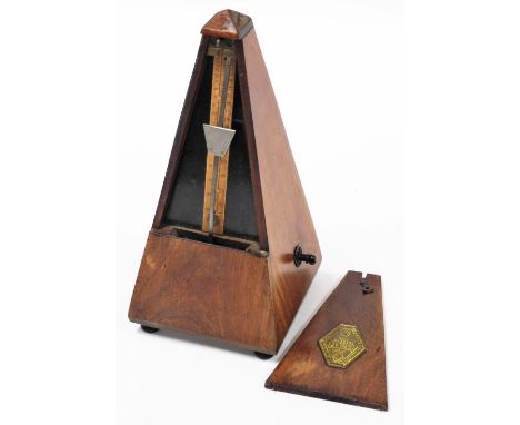 A Maelzel Paquet oak cased metronome, 22cm high. 