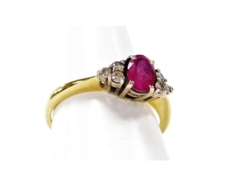 An 18ct gold ruby and diamond dress ring, the oval ruby in four claw setting, with three round brilliant cut diamond shoulder