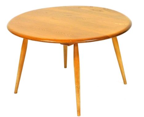 An Ercol light elm and beech circular coffee table, raised on four tapering cylindrical legs, 45cm high, 73cm diameter. 