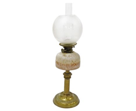 A Victorian brass oil lamp, with a pink frosted glass reservoir, glass chimney and frosted glass shade, with floral decoratio