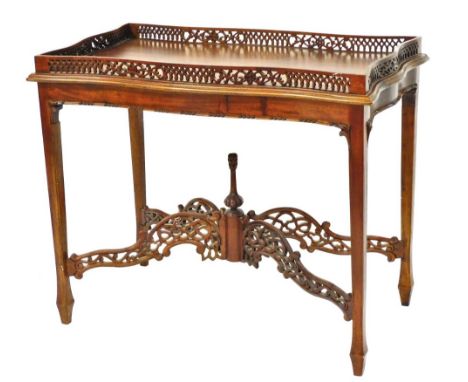 A Chippendale style sapele wood serpentine silver table, with a fret work galleried top, raised on tapering square legs and s