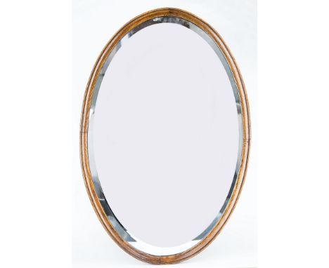 An oval oak surround mirror, 20 x 30in. (50.8 x 76.2cm.).