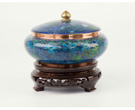 A modern Oriental cloisonné pot and cover, blue and green floral enamel work on dark blue ground, cover with turned brass fin