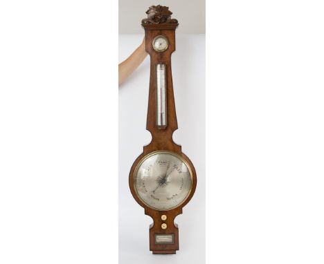 A George IV mahogany wheel barometer by J. Ronketti, circular hygrometer with brass bezel rectangular thermometer above large