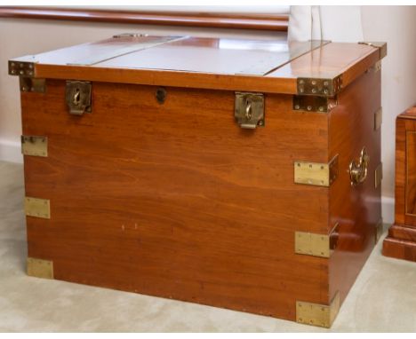 A large Victorian brass bound teak campaign trunk, with two large brass straps to top, brass corners and edge mounts over dov