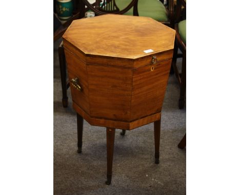 A Regency cross banded mahogany wine cooler, octagonal form, hinged lid with ebonised strung borders on inlaid tapering spade