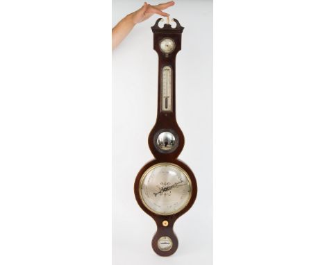 A Regency mahogany wheel barometer, swan neck pediment with ivory finial, hygrometer and thermometer above eight inch baromet