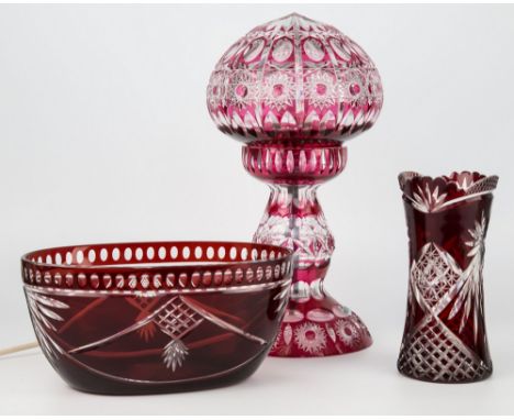 Ruby flashed cut-glass lamp, bowl and vase, the electric lamp with compressed globular shade over baluster form base with fla