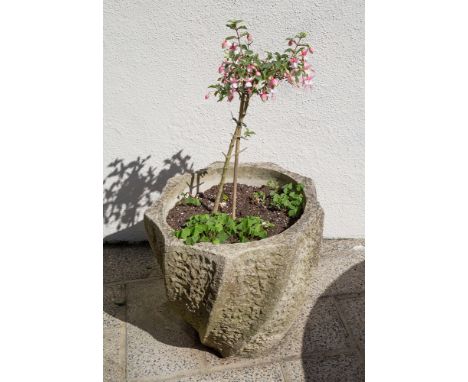 A composite stoneware planter, of circular form with scalloped spiral design to exterior, 19in. (48.3cm.) high.