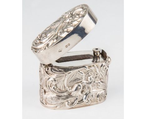 A Victorian silver oval vesta case, William Comyns, London 1891, of deep oval form with repousse floral and avian decoration,