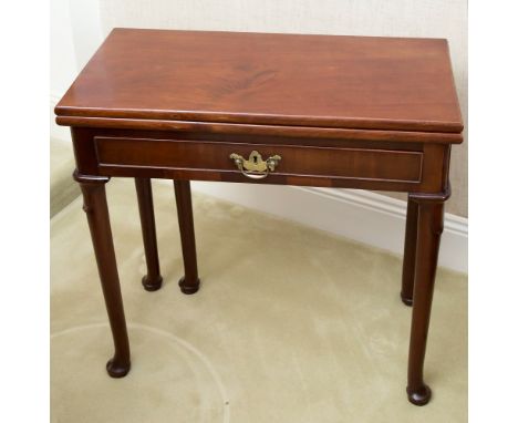 A George II red walnut tea table, fold over hinged opening on a single gate leg to rear, single drawer to front with moulded 