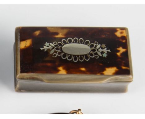 A horn snuff box, late 19th century, of rectangular form, the hinged lid inlaid with tortoise-shell and bearing silver oval r