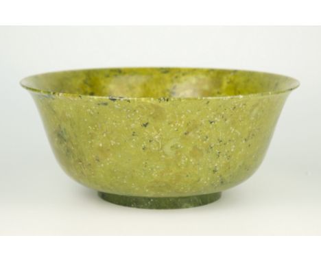 A Chinese spinach jade bowl, Qianlong style but possibly later, flared rim descending into deep rounded sides supported on sl