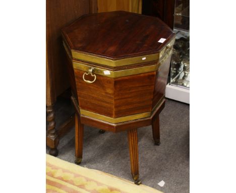 A George III mahogany cellarette, circa 1790, octagonal brass bound wine cooler with lead lining, hinged brass handles to sid