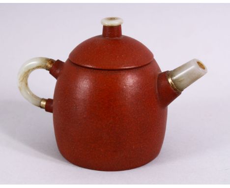 A CHINESE YIXING CLAY TEAPOT MOUNTED WITH A JADE HANDLE, SPOUT AND FINIAL, the base with an impressed mark, with white metal 