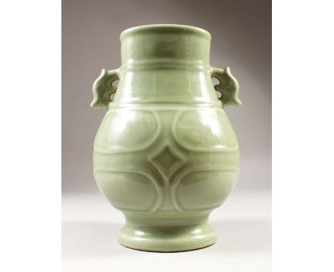 A CHINESE CELADON PORCELAIN RIBBED HU VASE, the base with a six-character mark to base, 20.8cm wide including handles, 28.1cm